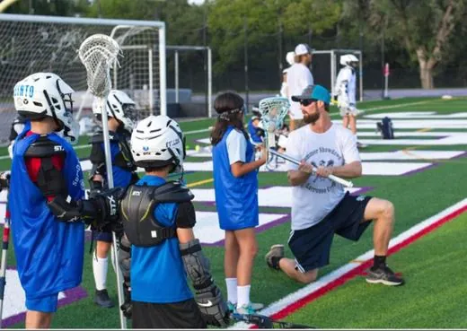 Coach Paul coaching a young player up close