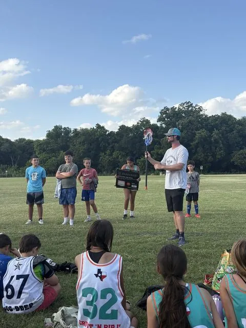 Coach Paul talking with players at practice