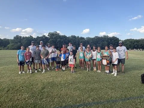 Group photo of players and coaches after a session