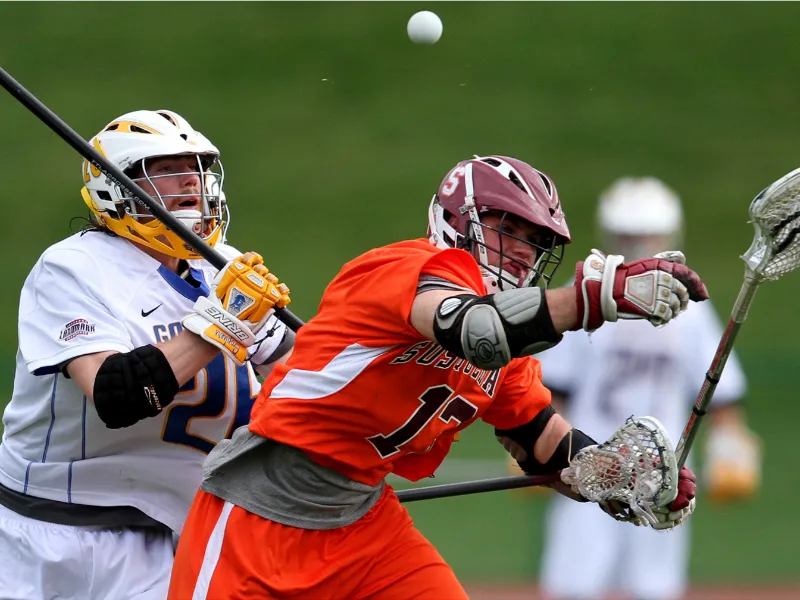 Coach Paul Taylor playing lacrosse during his college career