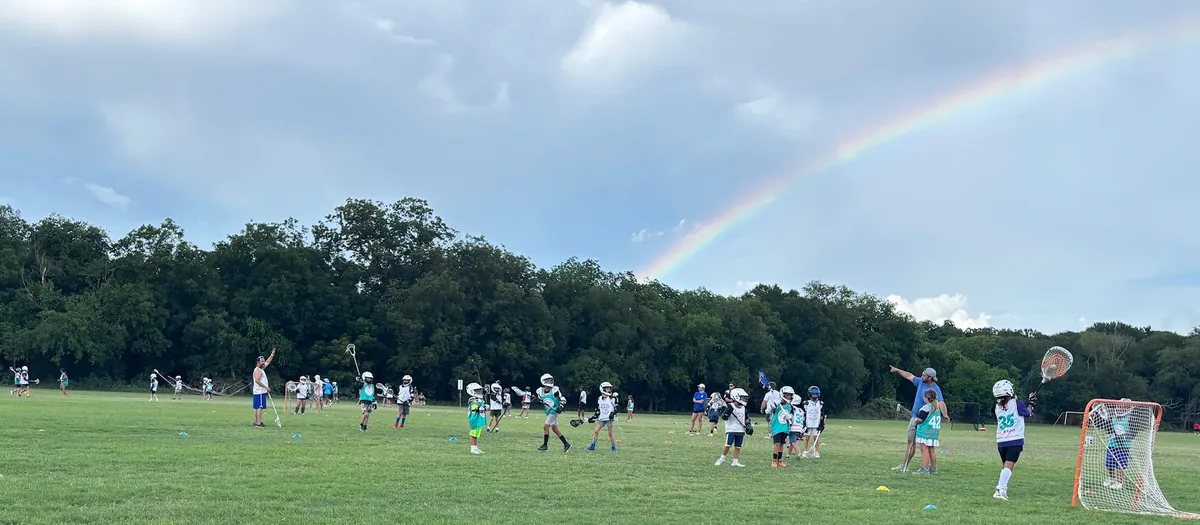 Youth lacrosse game under a rainbow at Olmos Basin Soccer Fields in San Antonio