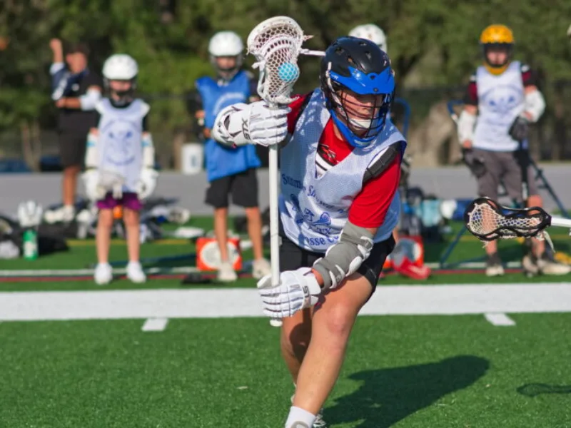Young lacrosse players on the turf in San Antonio
