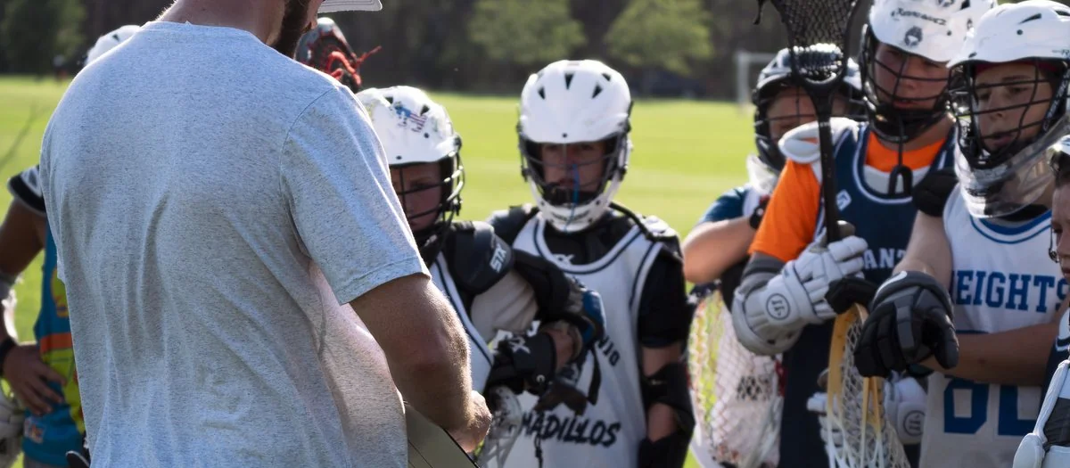 Coach Paul Taylor coaching a group of San Antonio lacrosse players