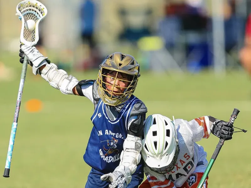 Youth lacrosse player driving to the goal in San Antonio